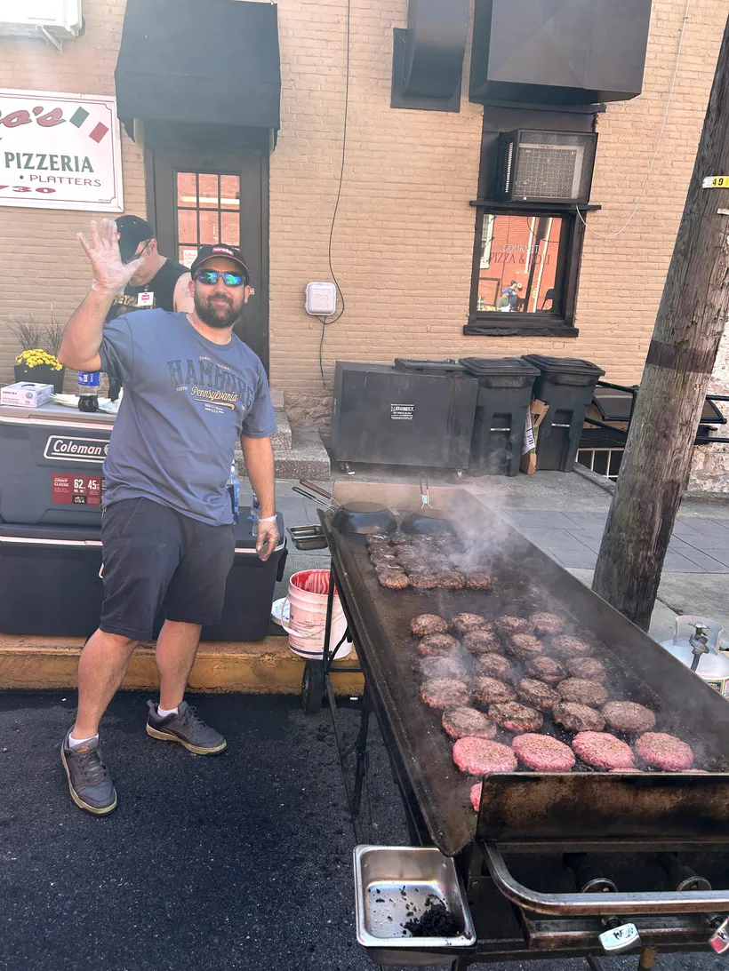 Burgers cooking on the grill at the Taste of Hamburg-er Festival.